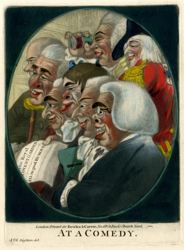 Eine Gruppe lachender Menschen in einem Kreis bei einer Comedy-Veranstaltung, mit einer Person, die ein Blatt Papier hält.