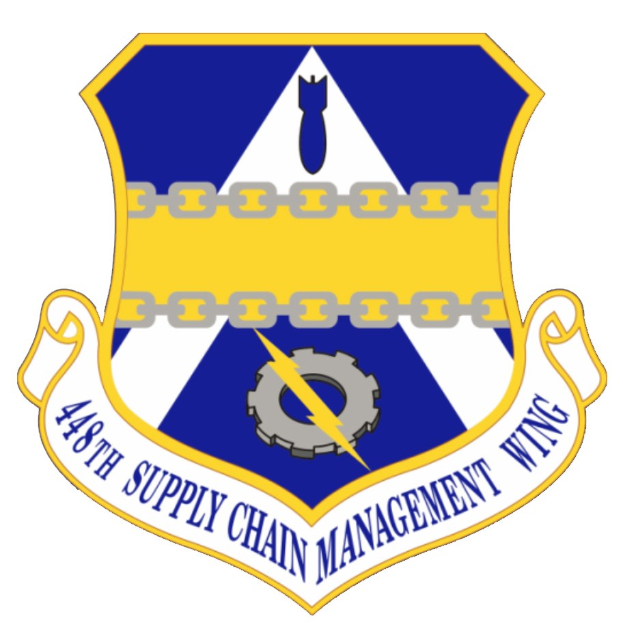 Logo des 48. Versorgungsmanagementgeschwaders mit einem blauen Schild mit einem weißen Stern, einem weißen Banner mit blauer Schrift 'Versorgungsmanagement' und schwarzer Schrift '48. Versorgungsmanagementgeschwader' in fetter Schrift.