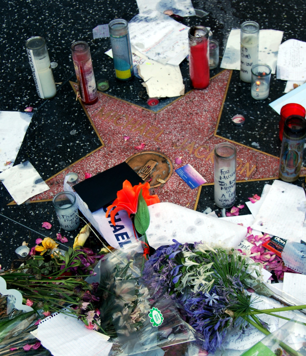 Star auf dem Hollywood Walk of Fame umgeben von Blumen, Kerzen, Papieren und anderen Gedenkgegenständen.